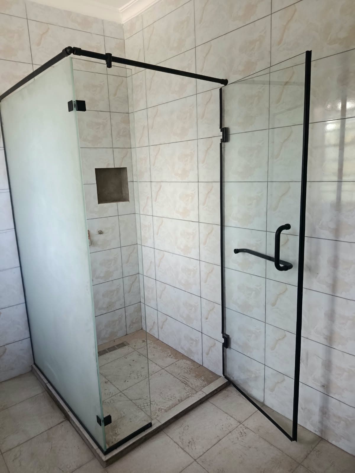 Black-frame frosted shower cubicle