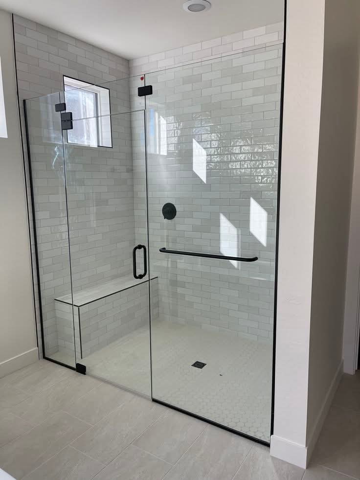 Frameless shower with black hardware